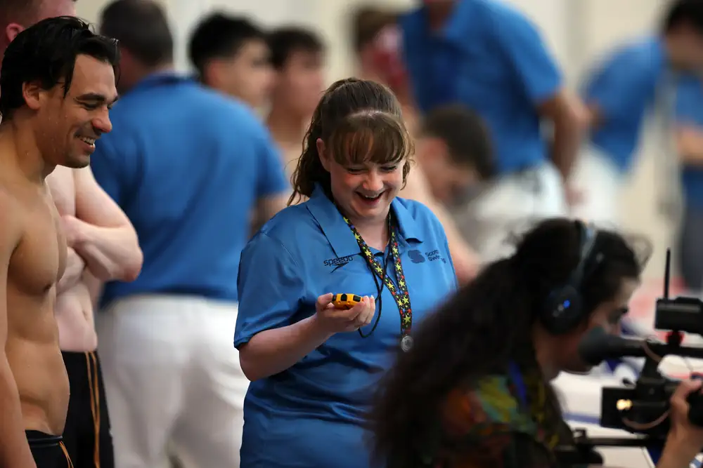 DASC volunteer timekeeping at a meet